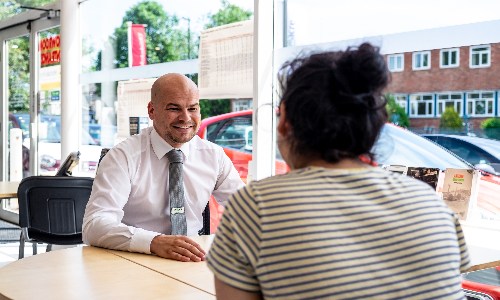 Nearly new car deals; salesperson and customer in dealership