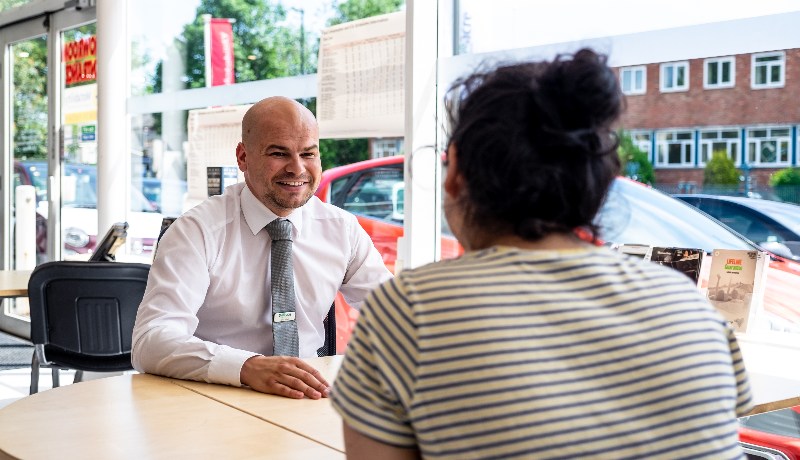 Nearly new car deals; salesperson and customer in dealership